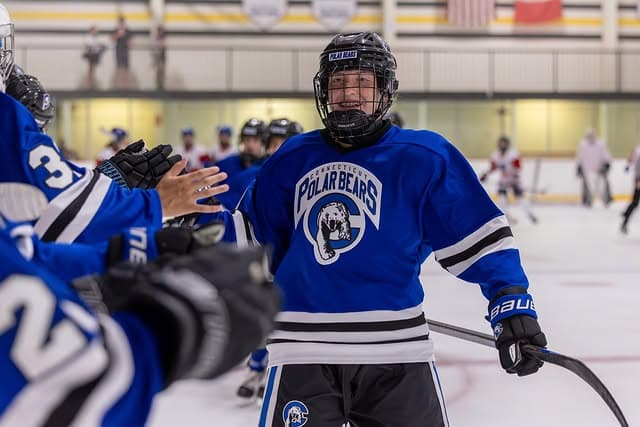 14 Majors celebrating their advance to the Beantown Classic championship game